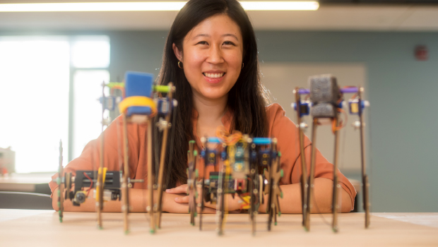 student with robotic toys