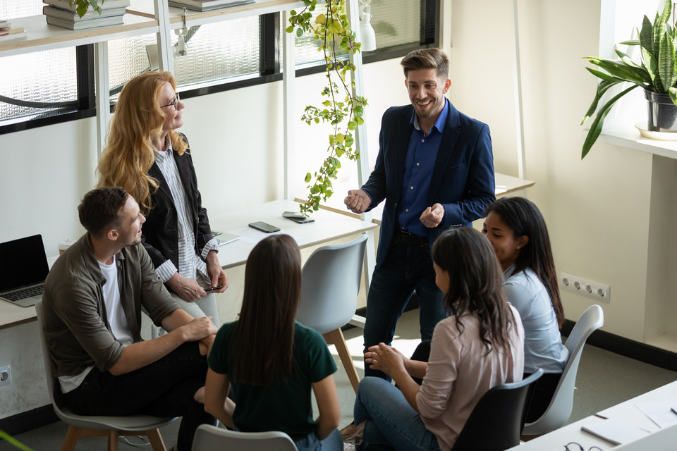 people gathered in an office chatting informally