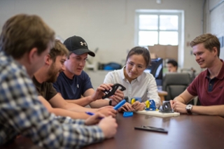 group of grad students looking at a something