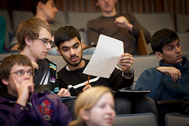students comparing notes in lecture