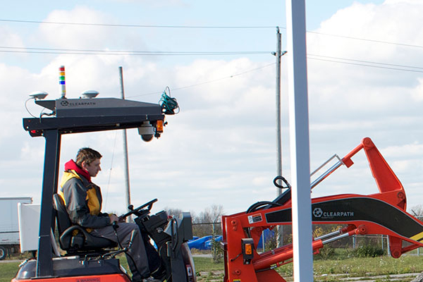 researchers working in the field with heavy machinery