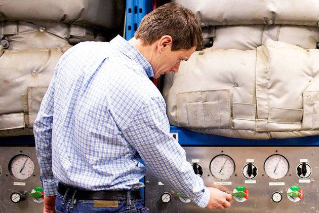 male researcher looking at equipment