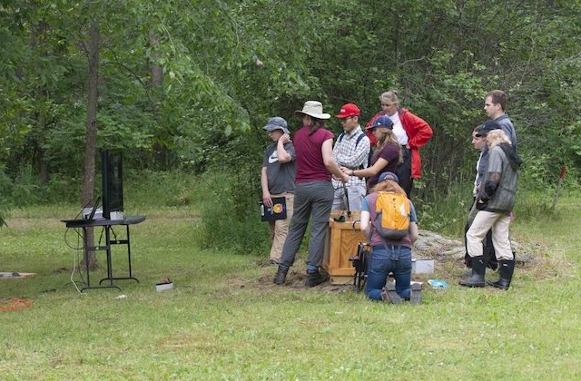 researchers doing fieldwork in a wooded area