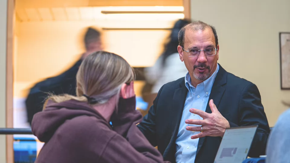 Dean Deluzio talking with a student about Reimagining Engineering Education.